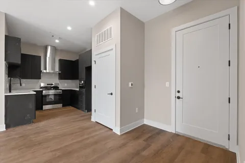 a view of kitchen with granite countertop refrigerator and microwave