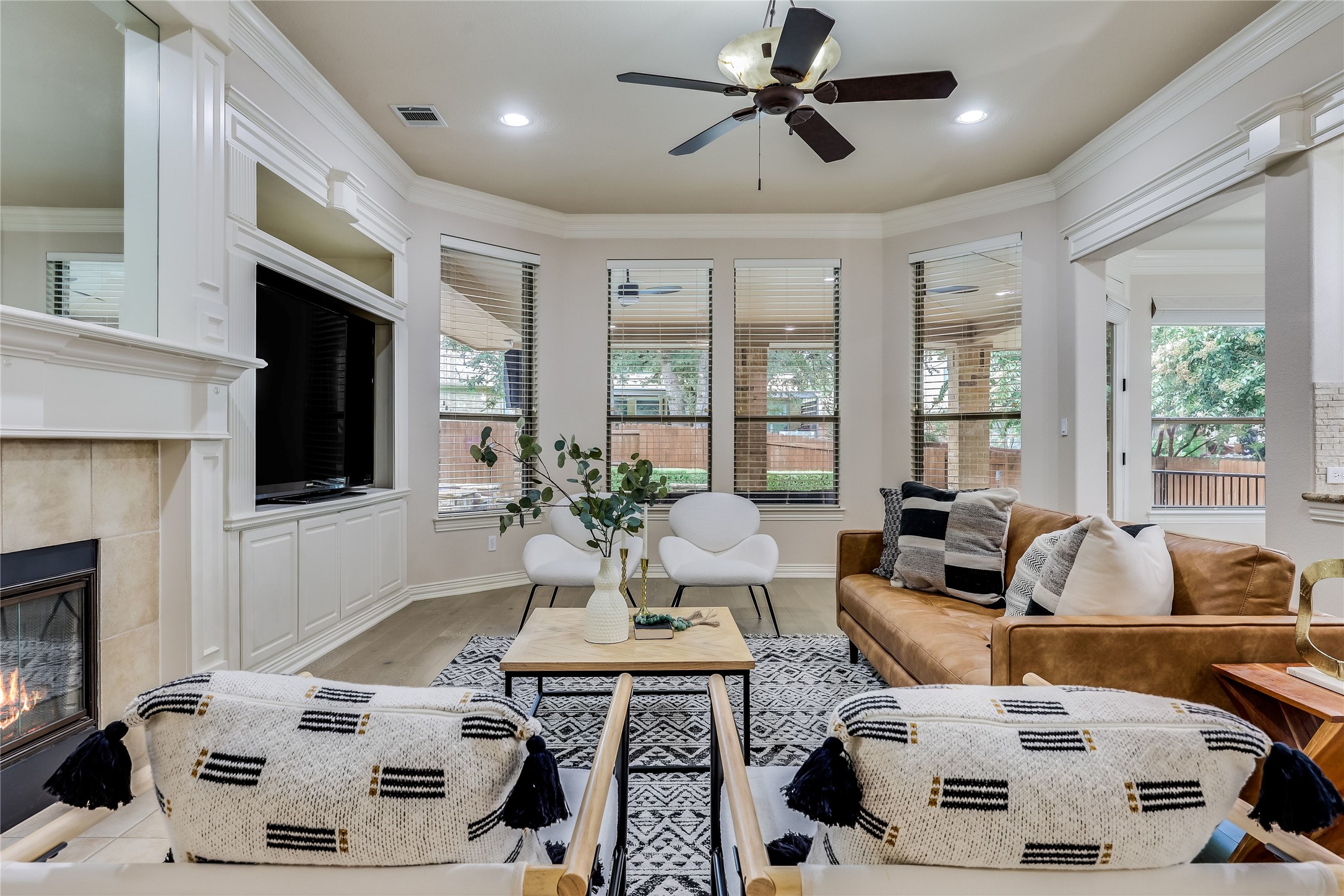 408 Ridgetop Bend Cedar Park, TX 78613 - Photo 5 of 40 A welcoming living area showcases a cozy fireplace and abundant natural light through multiple windows.