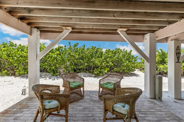a view of a chairs and table in the balcony