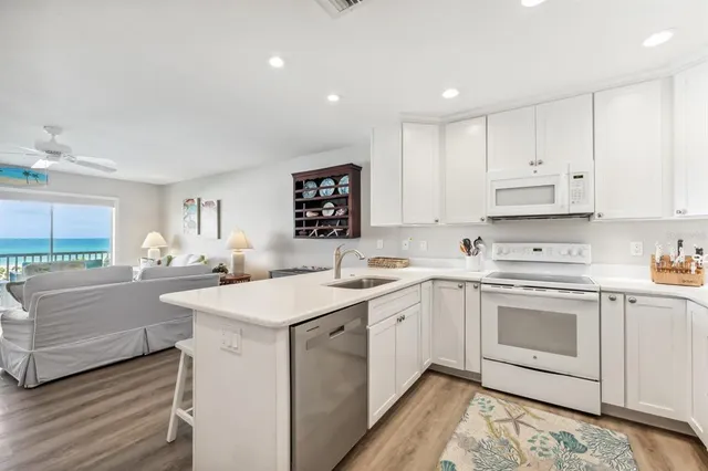 a kitchen with stainless steel appliances granite countertop a sink and cabinets