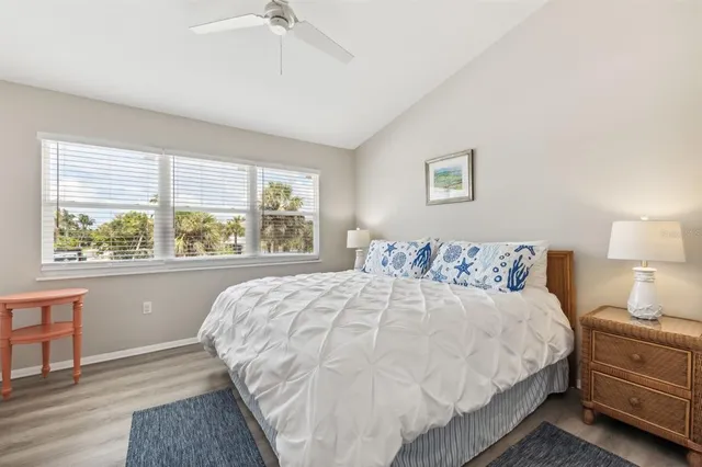 a bedroom with a large bed and a window