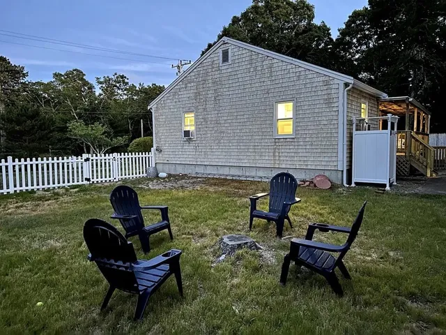 a view of a house with backyard and sitting area