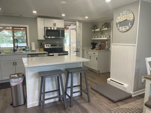 a kitchen with a refrigerator and a stove top oven
