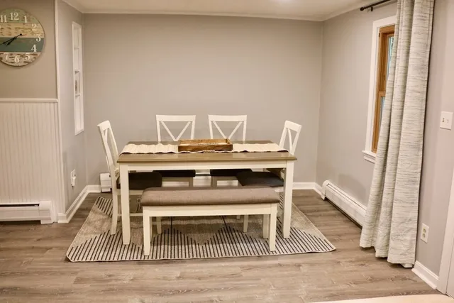 a view of a dining room with a table and chairs