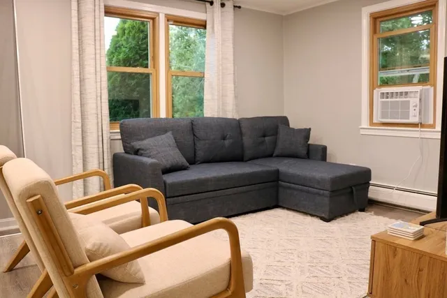 a living room with furniture and a window