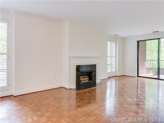 808 Cherokee Road, Unit J1 Charlotte, NC 28207 - Photo 3 of 16 an empty room with windows and fireplace
