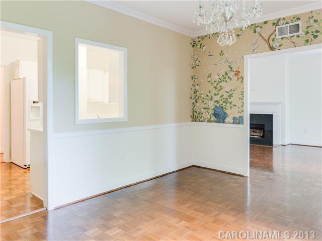 808 Cherokee Road, Unit J1 Charlotte, NC 28207 - Photo 5 of 16 a view of empty room with wooden floor and fireplace