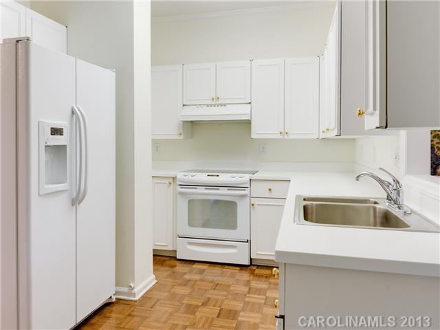 808 Cherokee Road, Unit J1 Charlotte, NC 28207 - Photo 6 of 16 a kitchen with a sink a stove and refrigerator