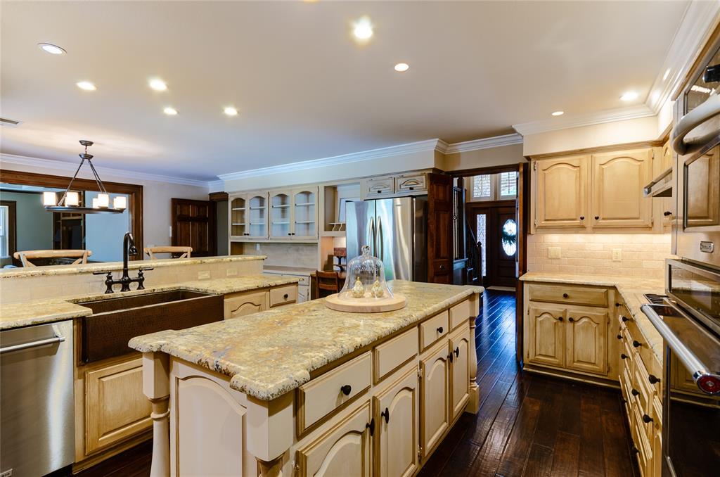 2605 Rothland Lane Plano, TX 75023 - Photo 12 of 40 a kitchen with stainless steel appliances granite countertop a sink and cabinets