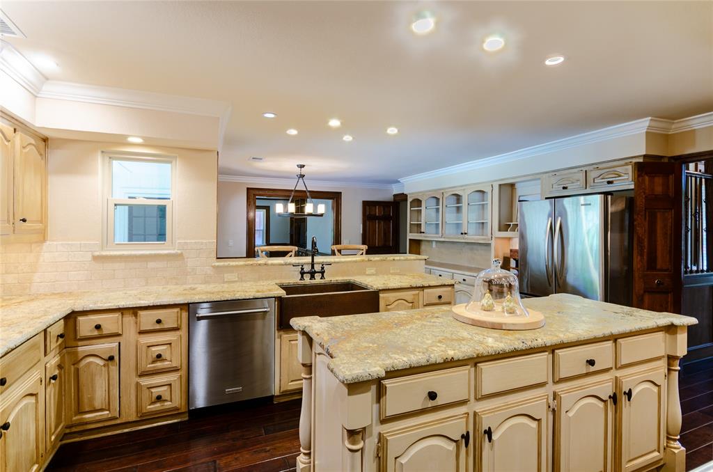 2605 Rothland Lane Plano, TX 75023 - Photo 13 of 40 a kitchen with granite countertop cabinets a sink a counter space and stainless steel appliances