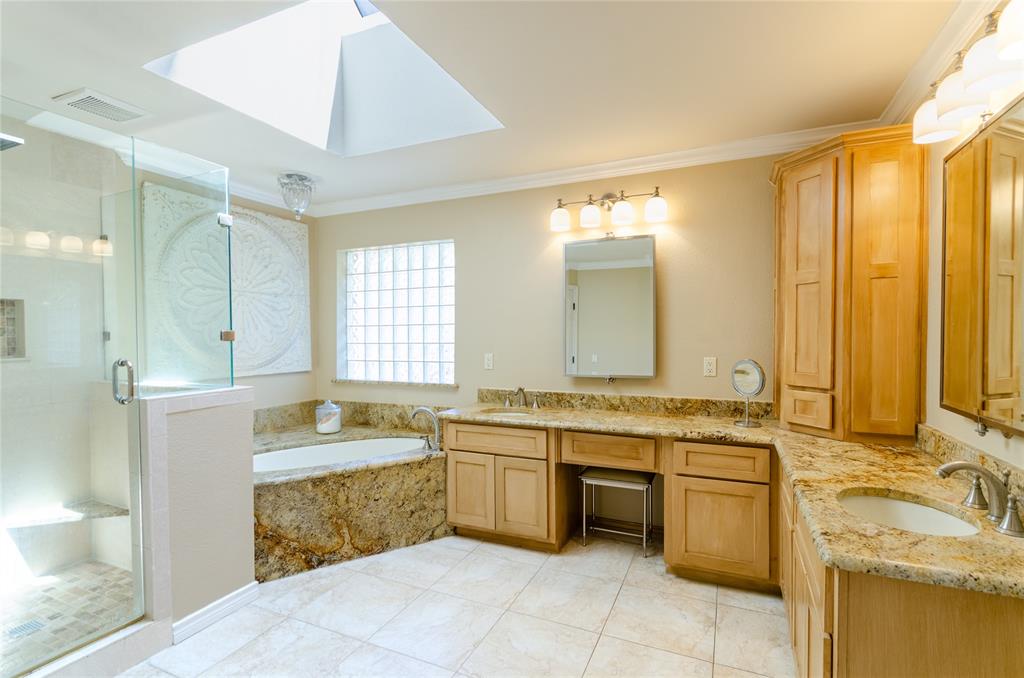 2605 Rothland Lane Plano, TX 75023 - Photo 19 of 40 a large bathroom with a tub sink and mirror