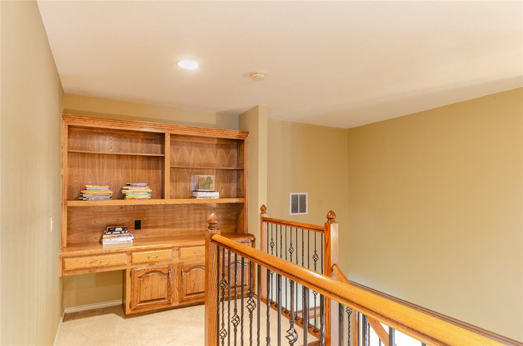 2605 Rothland Lane Plano, TX 75023 - Photo 32 of 40 a view of a hallway with wooden floor and dining room