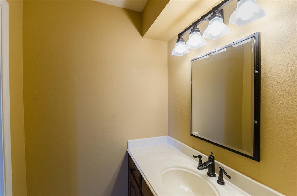 2605 Rothland Lane Plano, TX 75023 - Photo 35 of 40 a bathroom with a sink and a mirror