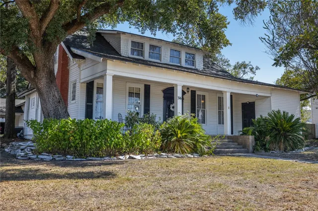 a front view of house with yard and green space