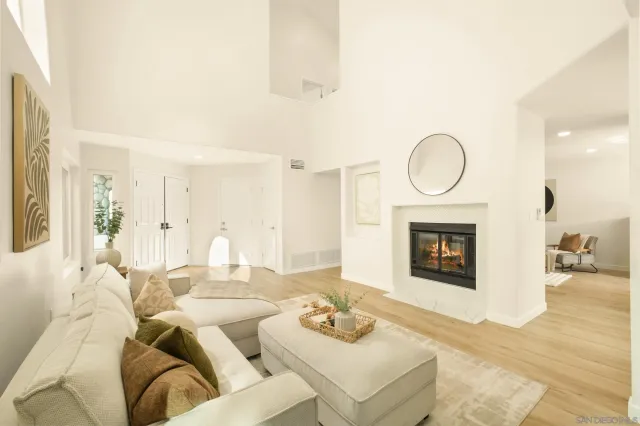 a living room with furniture a fireplace and a table