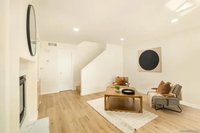 a living room with furniture and a mirror
