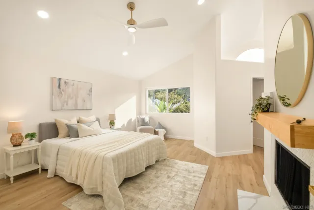 a bedroom with a bed and a large window