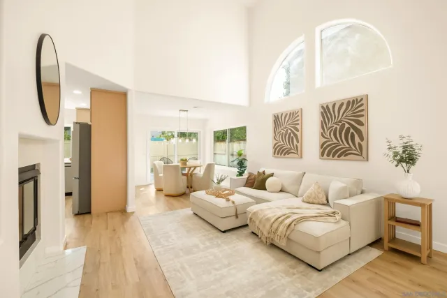 a living room with furniture and a large mirror