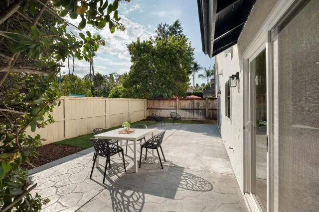 an aerial view of residential houses with outdoor space and trees