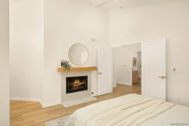 a bedroom with a fireplace and a chair