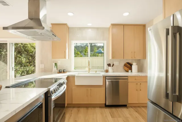 a kitchen with a sink stove and cabinets