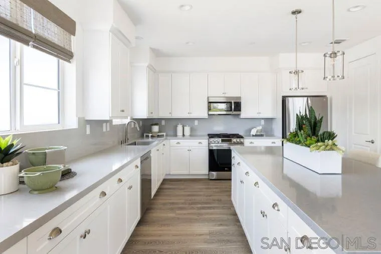 2220 South Ava Glen, Unit 906 Escondido, CA 92025 - Photo 12 of 23 a kitchen with stainless steel appliances a white stove top oven a sink a window and white cabinets