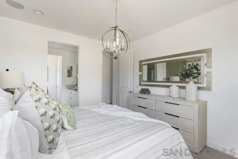 2220 South Ava Glen, Unit 906 Escondido, CA 92025 - Photo 16 of 23 a bedroom with a large bed and a chandelier
