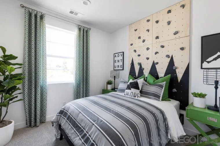 2220 South Ava Glen, Unit 906 Escondido, CA 92025 - Photo 19 of 23 a bedroom with a bed a flat screen tv and a potted plant