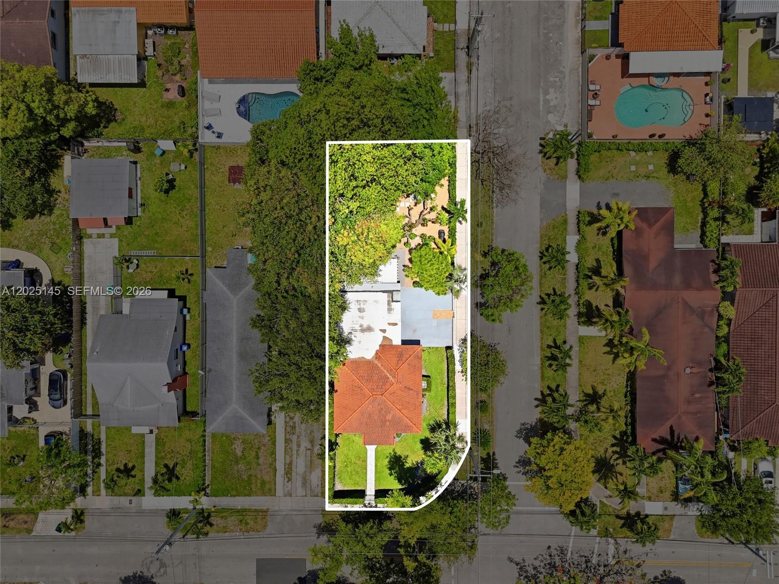 3101 Southwest 25th Terrace Miami, FL 33133 - Photo 31 of 31 an aerial view of a residential apartment building with yard and parking spaces