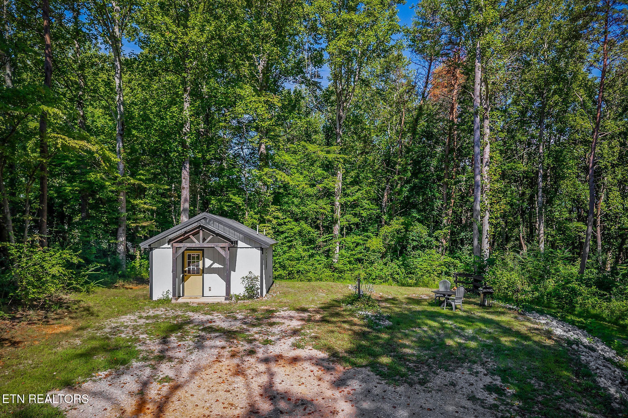 3247 Moodyville Road Byrdstown, TN 38549 - Photo 3 of 27 a front view of a house with a yard and trees