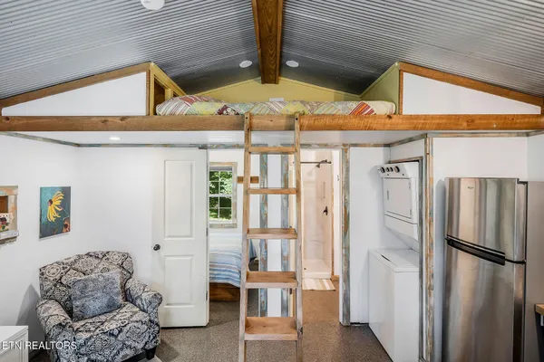 a kitchen with stainless steel appliances kitchen island granite countertop a refrigerator and a stove