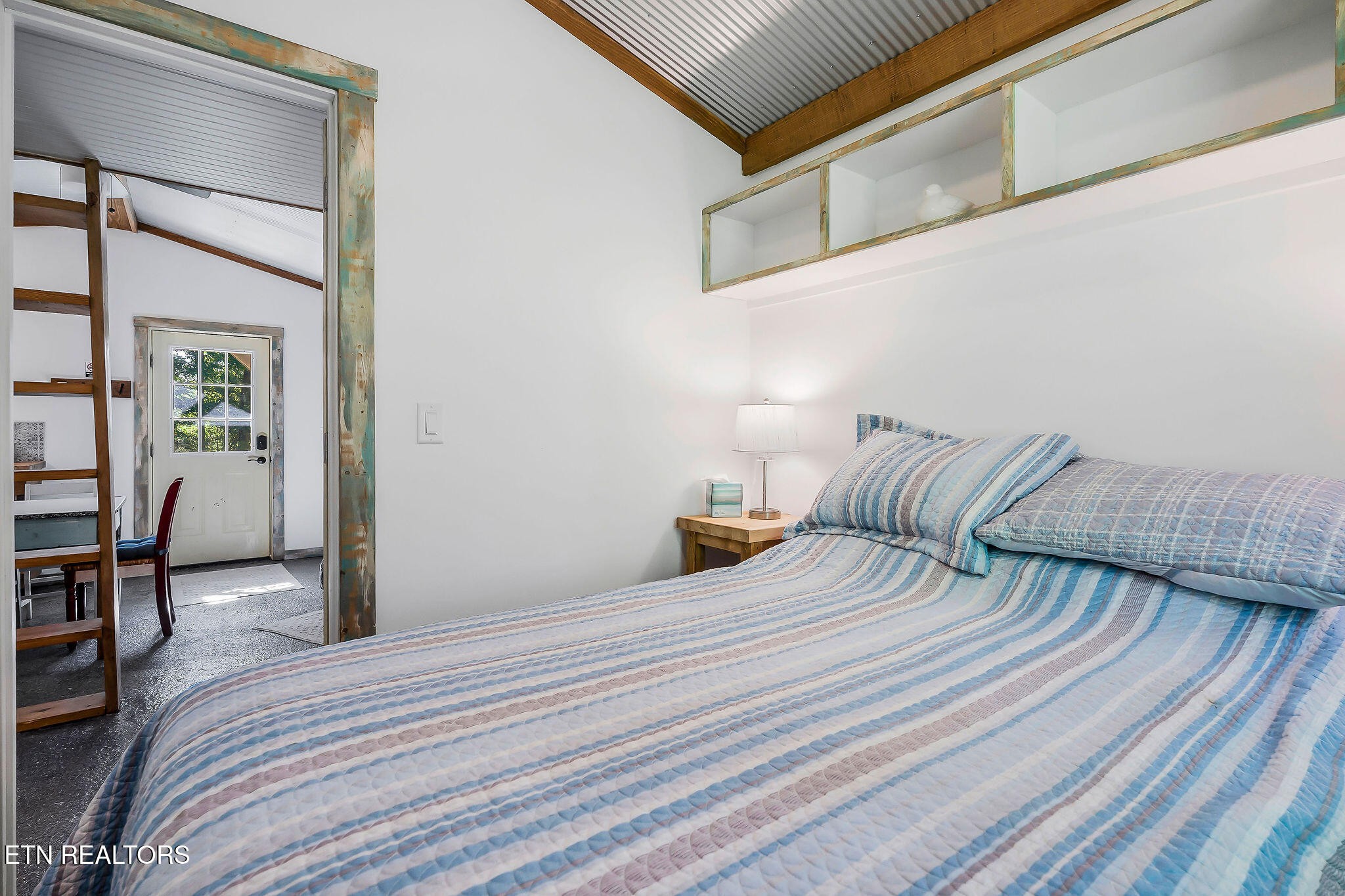 3247 Moodyville Road Byrdstown, TN 38549 - Photo 9 of 27 a bedroom with a bed and table chair