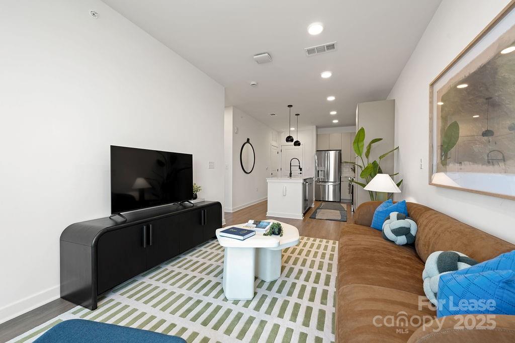 4101 Raleigh Street, Unit S2 Charlotte, NC 28206 - Photo 39 of 48 a living room with furniture and a flat screen tv