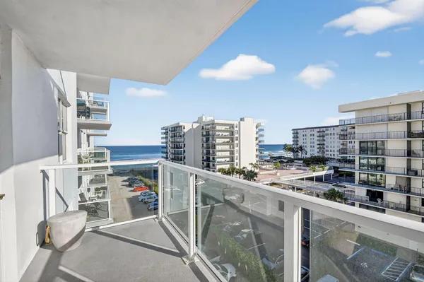 a view of a kitchen with fridge and workspace