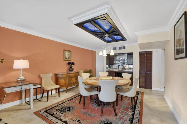 a dining room with furniture a rug and wooden floor