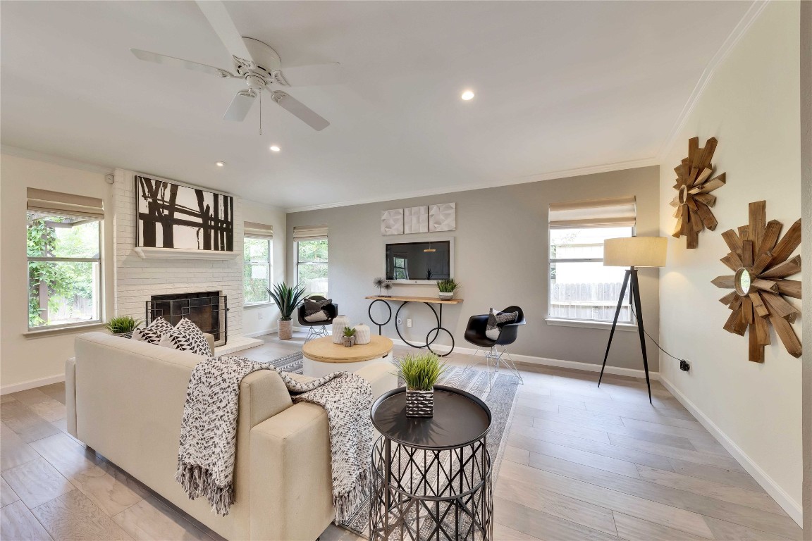 a living room with fireplace furniture and a wooden floor