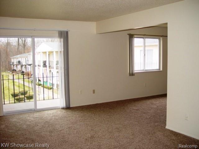 5251 Highland Road, Unit 213 Waterford, MI 48327 - Photo 3 of 15 LIVING ROOM TO BALCONY