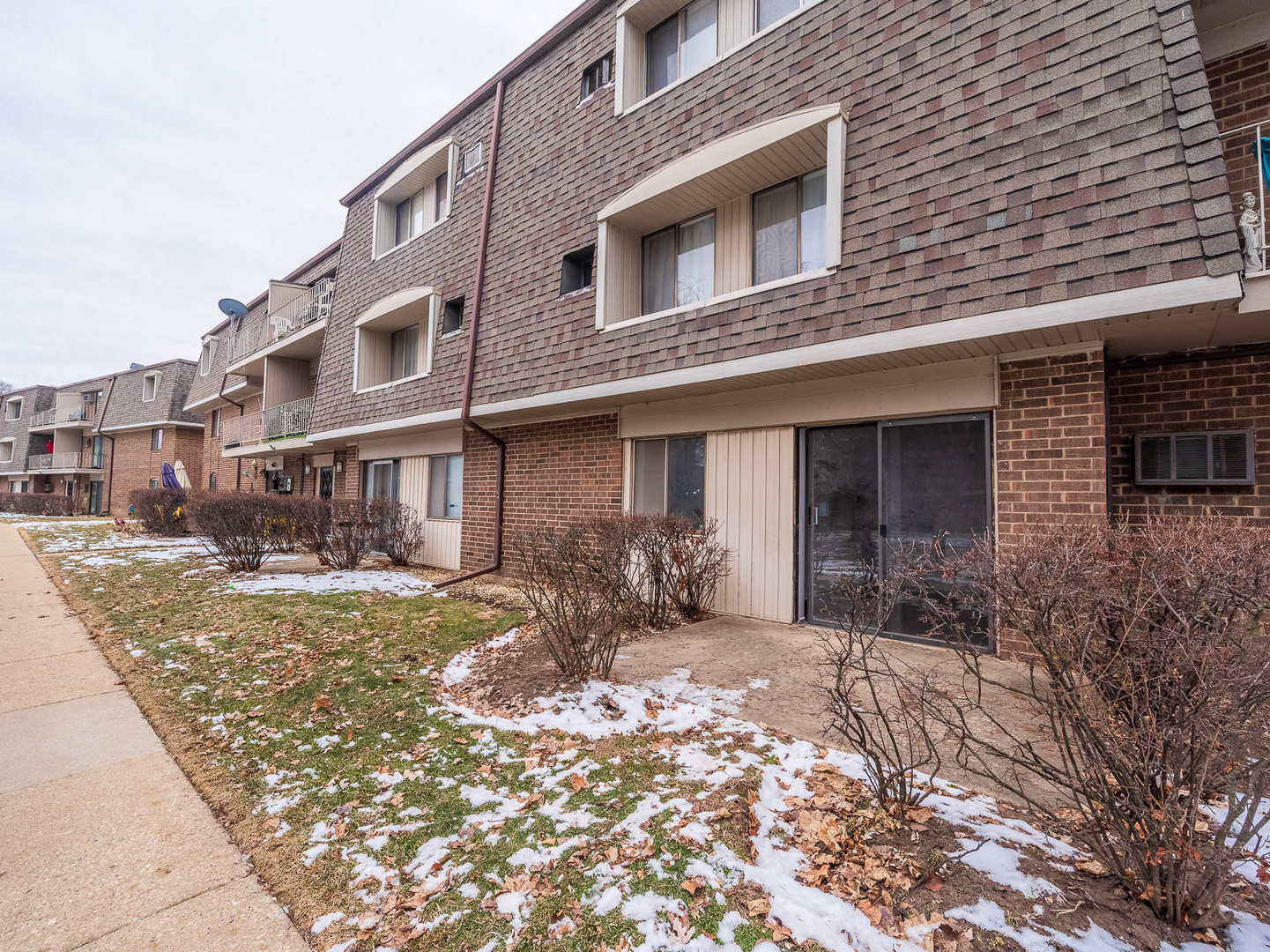 144 East Bailey Road, Unit D Naperville, IL 60565 - Photo 7 of 8 a front view of a house with a yard