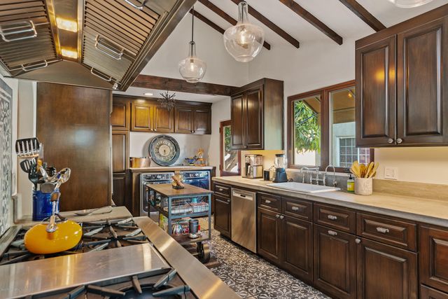 a kitchen with stainless steel appliances granite countertop a sink and cabinets