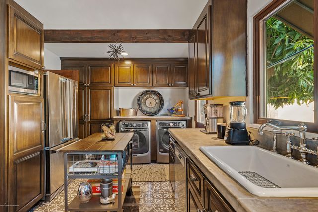 a kitchen with a refrigerator and a stove