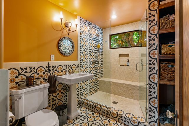 a bathroom with a toilet and a shower