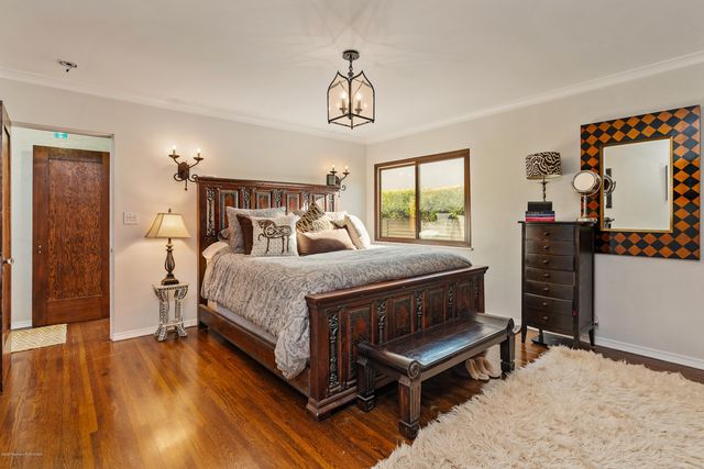 a bedroom with a bed a window and dresser