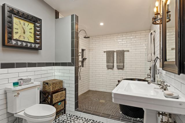 a bathroom with a sink a toilet and mirror