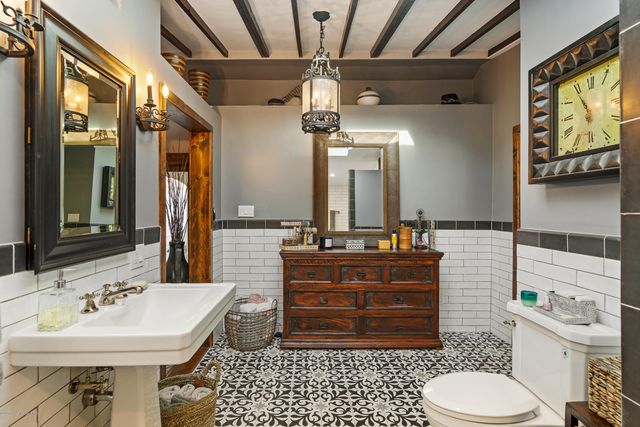 a bathroom with a sink a toilet and mirror