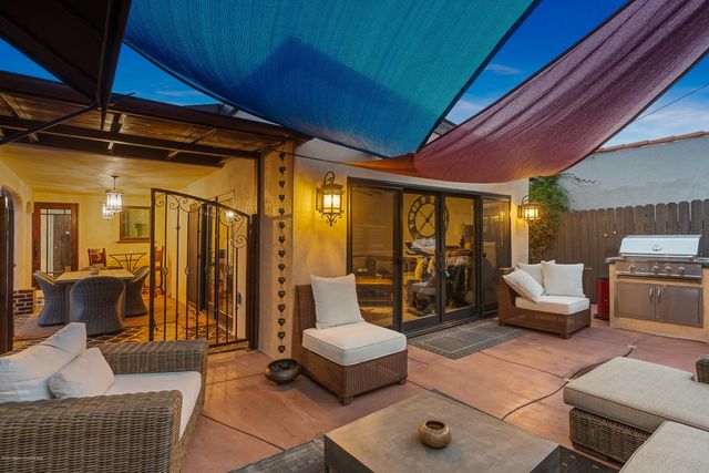 a patio with patio a table and chairs under an umbrella