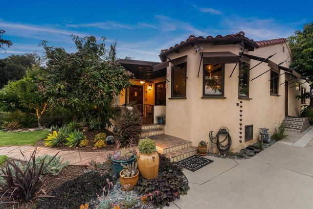 a front view of a house with garden