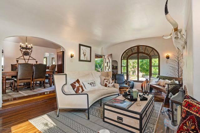 a living room with furniture chess table and a fireplace