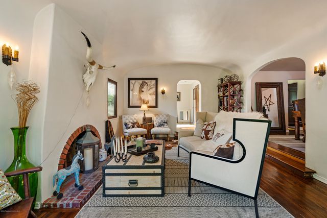 a living room with furniture a rug and white walls
