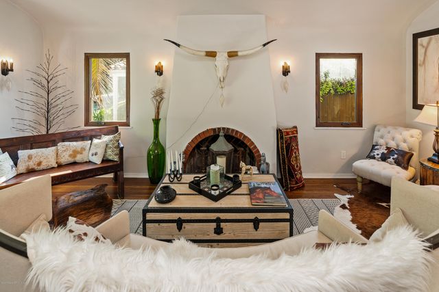 a living room with furniture a rug and a window