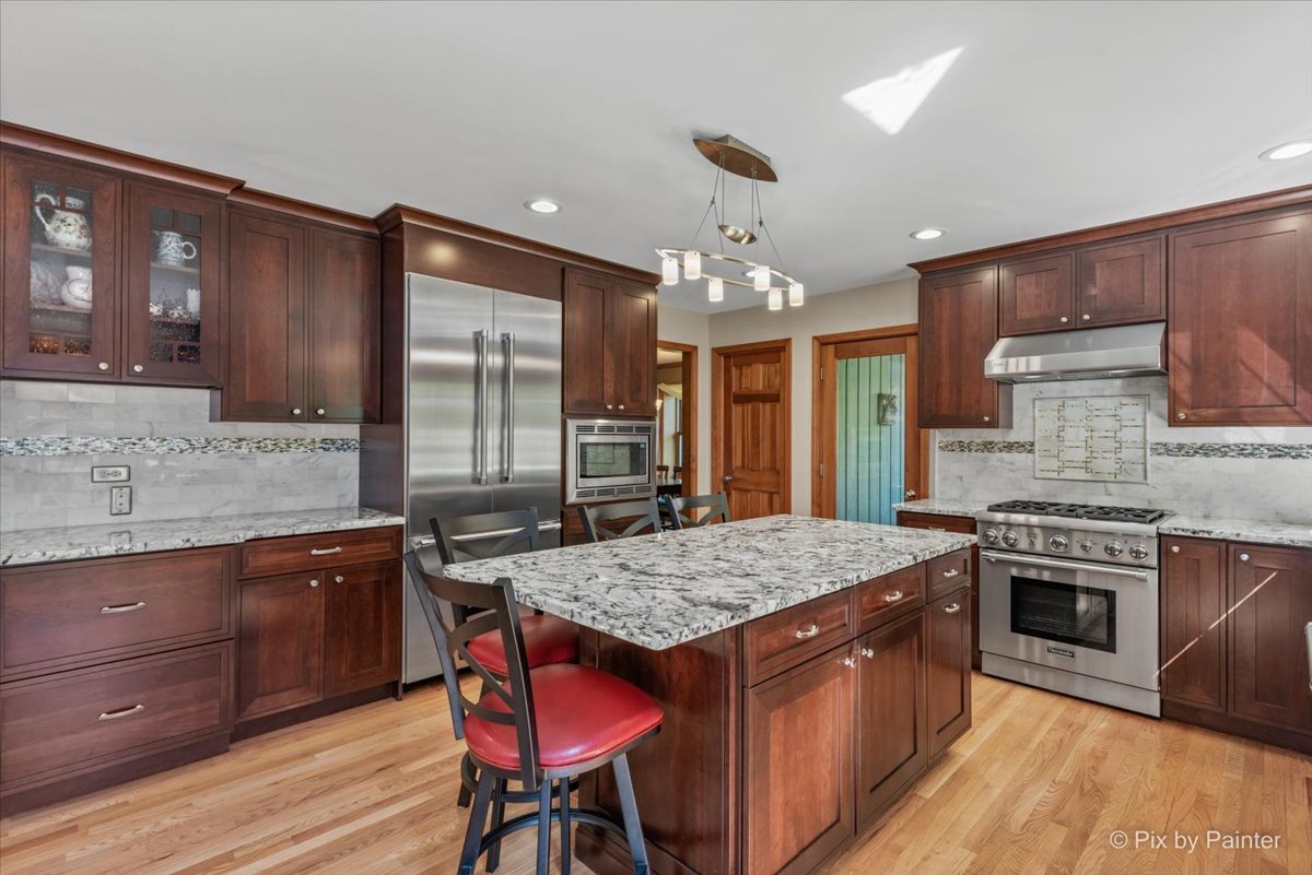 28683 Rivers Edge Drive Cary, IL 60013 - Photo 11 of 31 a kitchen with stainless steel appliances granite countertop wooden cabinets and a stove top oven
